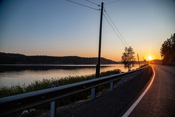 train on the road at sunset