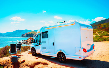 Camper on road at Capo Pecora at Mediterranean sea in Sardinia Island, Italy summer. Caravan...