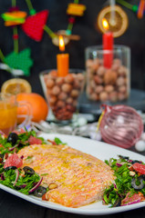 Oven baked salmon with grapefruit salad. Red Fish Steak served with salad and olive oil on plate.