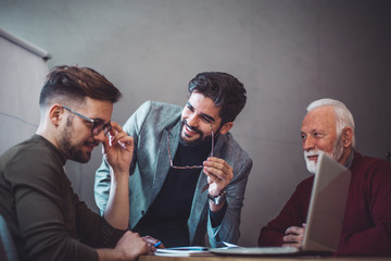 Two young executives and a senior manager at an office.