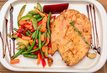 Grilled steaks, baked potatoes and vegetables