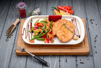 Grilled steaks, baked potatoes and vegetables