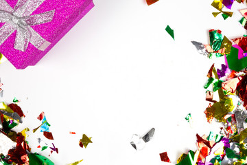 Multi-colored confetti and colorful presents isolated on white background, birthday or party background with space for text