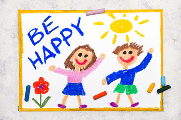Obraz na płótnie Canvas Photo of colorful drawing: Smiling boy and girl and phrase BE HAPPY. Positive thinking concept