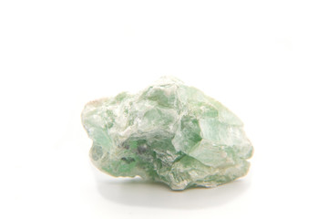 Macro shooting of natural gemstone. The raw mineral is talc. Isolated object on a white background.