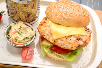 Tasty and appetizing hamburger cheeseburger. On a wooden table