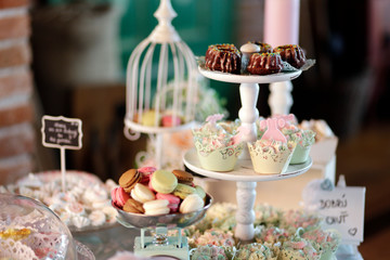 Candy bar at the wedding. Delicious wedding reception candy bar dessert table. Macaroon on candy bar, candy bar on holiday. 