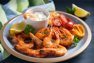 Shrimps or prawns with vegetables, garlic and sauce on plate