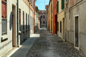 Fototapeta na wymiar Narrow medieval street in Ferrara, Italy
