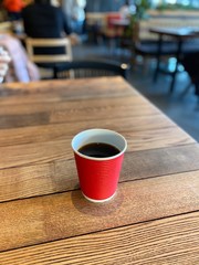 coffee in a red paper cup
