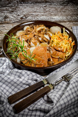 Stewed pork chop in a bright mushroom sauce.