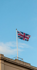 Union flag flying against a blue sky