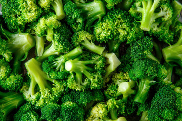 Macro photo green fresh vegetable broccoli. Fresh green broccoli on a black stone table.Broccoli vegetable is full of vitamin.Vegetables for diet and healthy eating.Organic food.