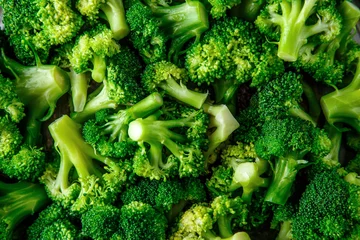Poster Macro photo green fresh vegetable broccoli. Fresh green broccoli on a black stone table.Broccoli vegetable is full of vitamin.Vegetables for diet and healthy eating.Organic food. © bukhta79
