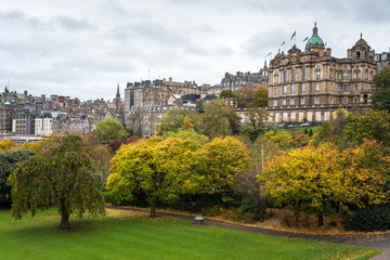 Edinburgh old town skyline with a park in foreground on a cloudy autumn day