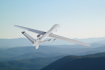 Fototapeta na wymiar Spy unmanned aerial vehicle (UAV) flies over low mountains in mist