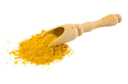 Yellow Curry Powder In The Wooden Spoon, Isolated On White Background.