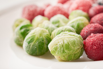 Close-up of frozen foods in a plate brussels sprouts with cherries