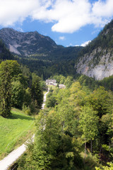 Hallstatt, Austria. Famous mountain village in the Austrian Alps on a warm autumn day. View of the mountains, forest, Austrian buildings and funicular.