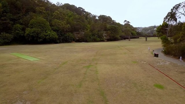 Aerial view of Flat Rock Creek sports area in Northbridge just past the Long Gully Bridge, Sydney Australia, drone flyover shot