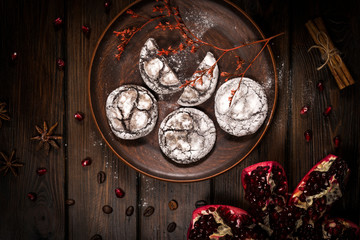 top view of chocolate chip cookies and pomegranate on wooden table background