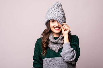 Beautiful woman look fun in winter hat and scarf isolated on gray background