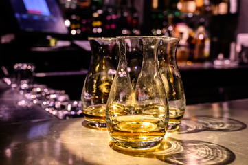 Scotch whisky, tasting glasses with variety of single malts or blended whiskey spirits on distillery tour in Scotland