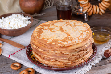 Big stack of thin pancakes with honey. Russian bliny. Maslenitsa.
