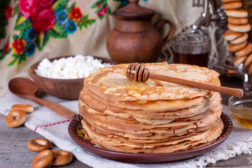 Big stack of thin pancakes with honey. Russian bliny. Maslenitsa.