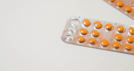 White and orange tablets in blisters. Health care wallpaper. Pharmaceutical company. Sickness treatment 