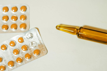 Ampoule with serum, pills and blisters. Pharmaceutical business wallpaper. Medical care. Vitamins...