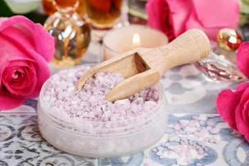 Tiny parfum bottle and other cosmetics around it.