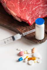 Injection of growth hormones and chemicals into raw beef. Biological experiments with antibiotics...