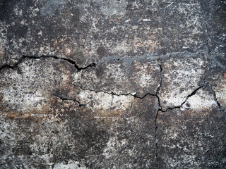 Cracked concrete texture closeup background. Dirty old rusty cement. Abstract textured road