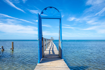 Beautiful blue door on the beach of Sandy Bay on the Roatan Island of the Caribbean Sea. Honduras