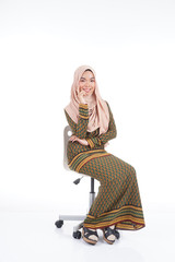 Fototapeta premium Female student in various poses wearing modern kurung, a modern urban lifestyle apparel for Muslim women isolated on white background. Beauty and hijab fashion concept.