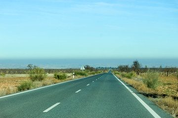 road to the horizon in the Gorafe badlands in Spain and blue sky