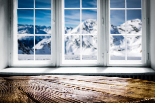 desk of free space and winter window background 