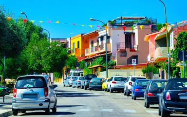 Obraz premium Street Cityscape of car road at Cagliari city at the Mediterranean Sea in South Sardinia in Italy. Sardinian Italian small town in Sardegna. Urban district. Province. Mixed media.