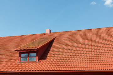 red tile roof with window and chimney