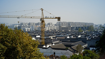 crane working in old Chinese town