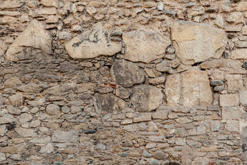 Old brick and stone wall. Multilayered wall with a square detail