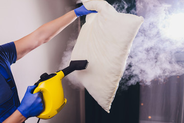 Using dry steam cleaner to sanitize pillow.