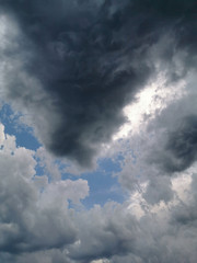 Dark clouds on blue sky