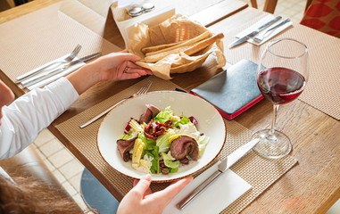 woman eating salad with beef