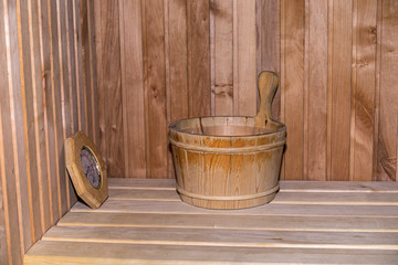 Wooden sauna with traditional sauna accessories