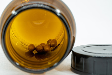 jar with brown pills, pharmacy or medication