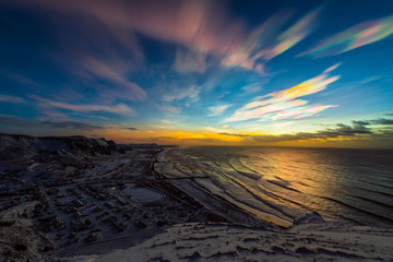 Fototapeta na wymiar Polar stratospheric clouds during sunrise. Coastline top view. January 2020, Vik, Iceland.