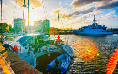 Harbor with Luxury ship at sunset or sunrise and Mediterranean Sea in Old city of Olbia on Sardinia...