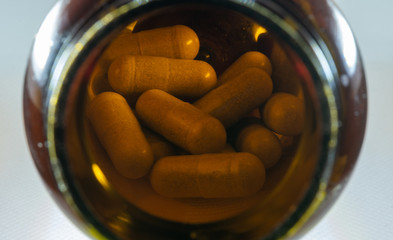 pills and bottle on white background